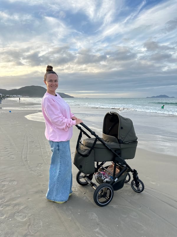 Woman with baby stroller enjoys beach day in Florianópolis