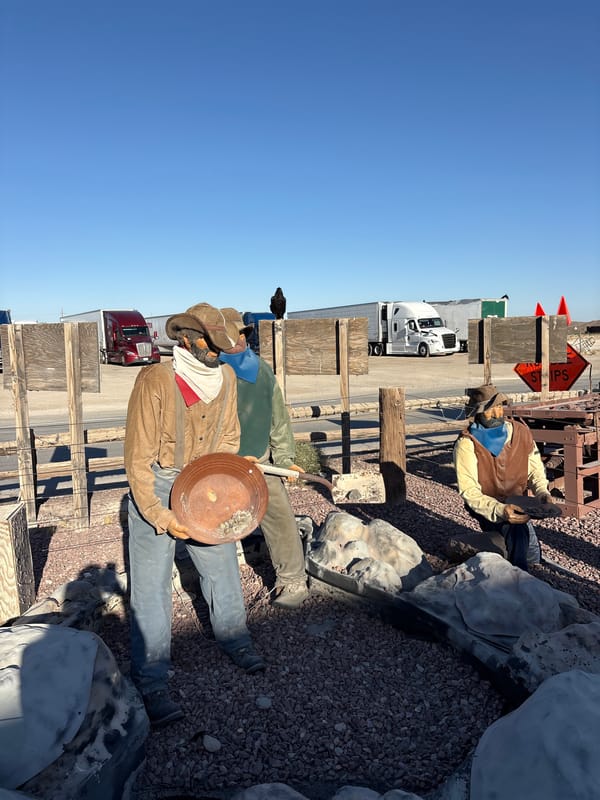 Route 66 roadside stop with signpost, wagon, and souvenirs