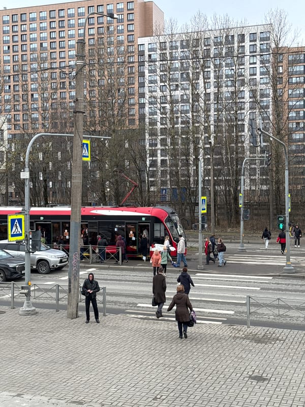 Tram navigates pedestrian crossing in Saint Petersburg morning commute