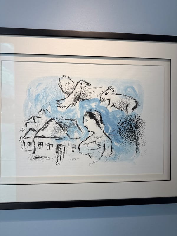 Gallery walls lined with surreal prints and Chagall lithographs