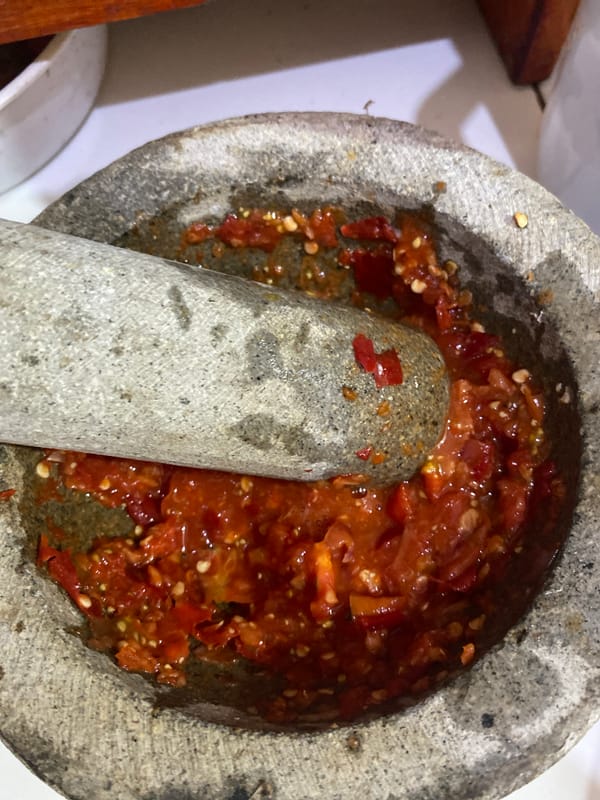 Late night food prep with chilies and corn in Ta', Indonesia