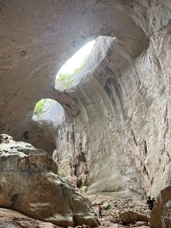 Natural light illuminates Devetashka Cave interior through roof openings