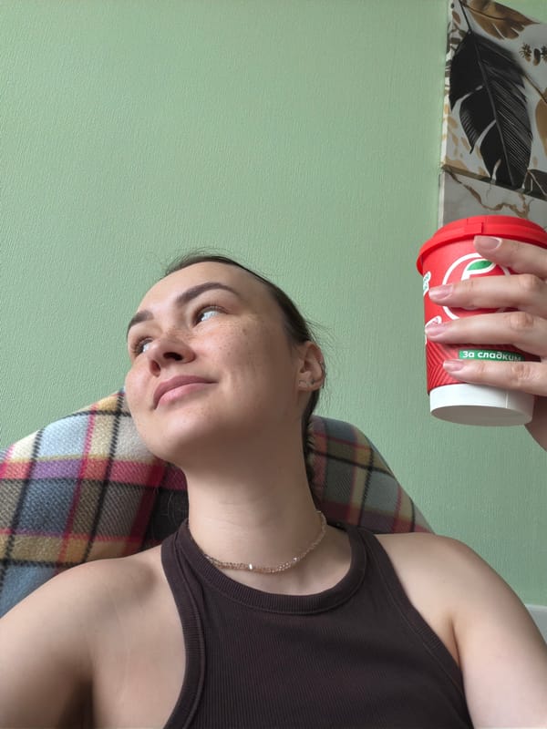 Relaxed indoor moment in Chaikovsky, red coffee cup in hand