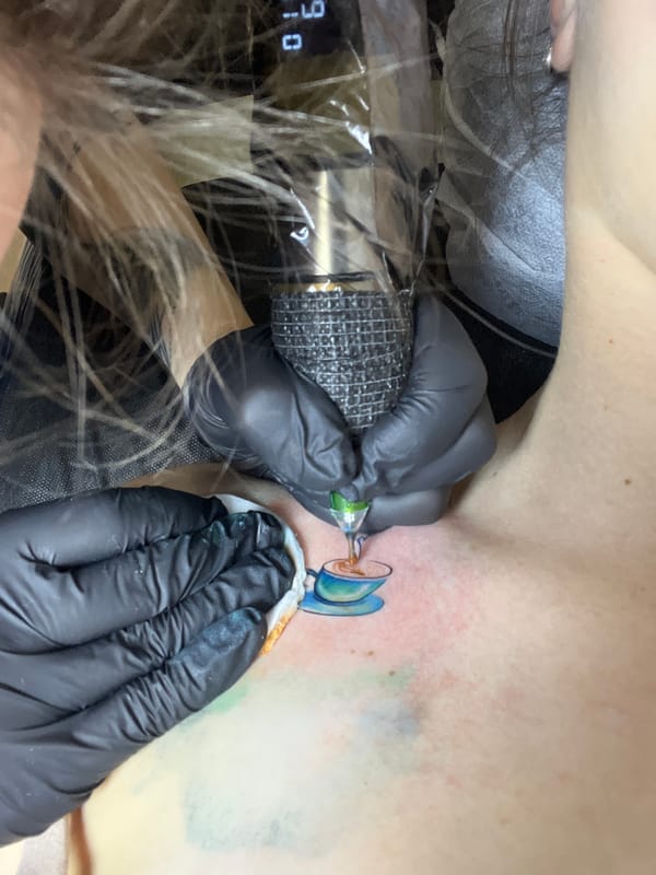 Woman gets teacup tattoo in Podgorica Montenegro parlor
