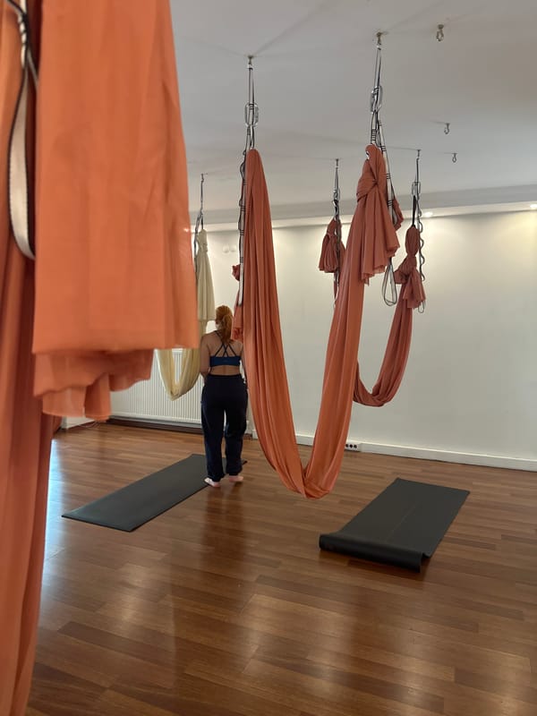 Woman practices aerial yoga at Esenyurt studio