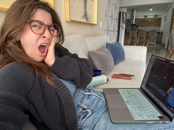 Woman makes playful faces on couch in Puebla