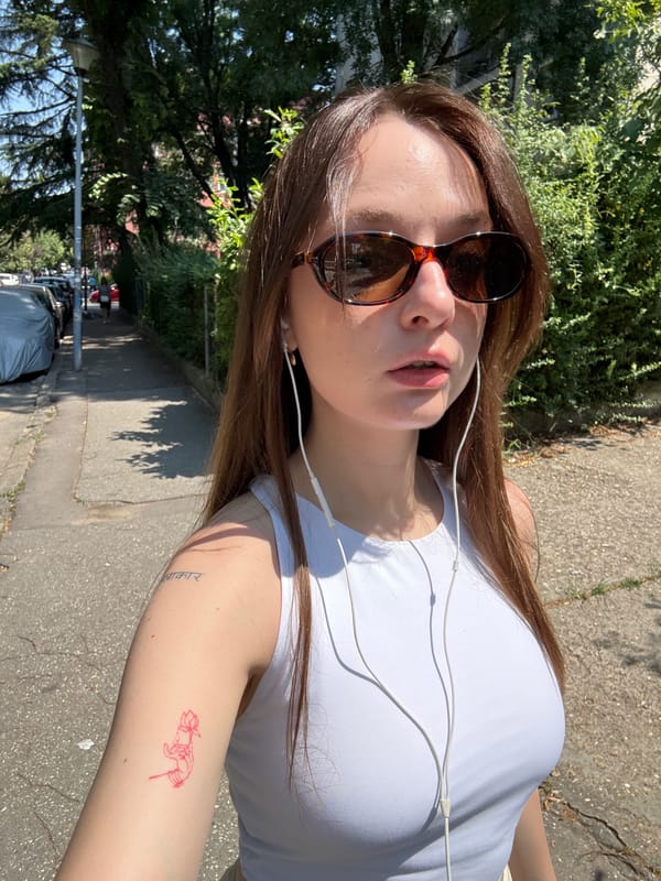 Sunny selfie moment in Belgrade, white earbuds and lotus tattoo