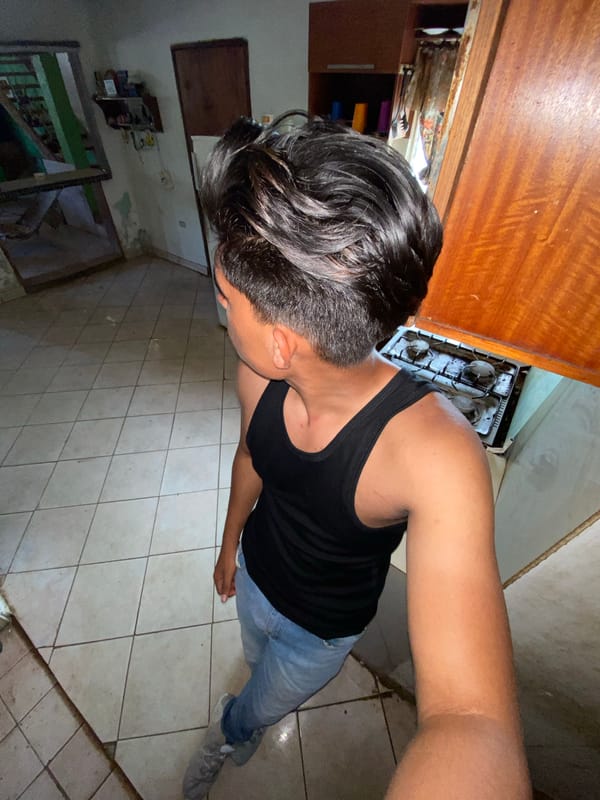 Man documents evening meal preparation routine in Venezuelan kitchen