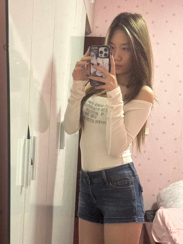 Person takes mirror selfie in Shapingba District bedroom