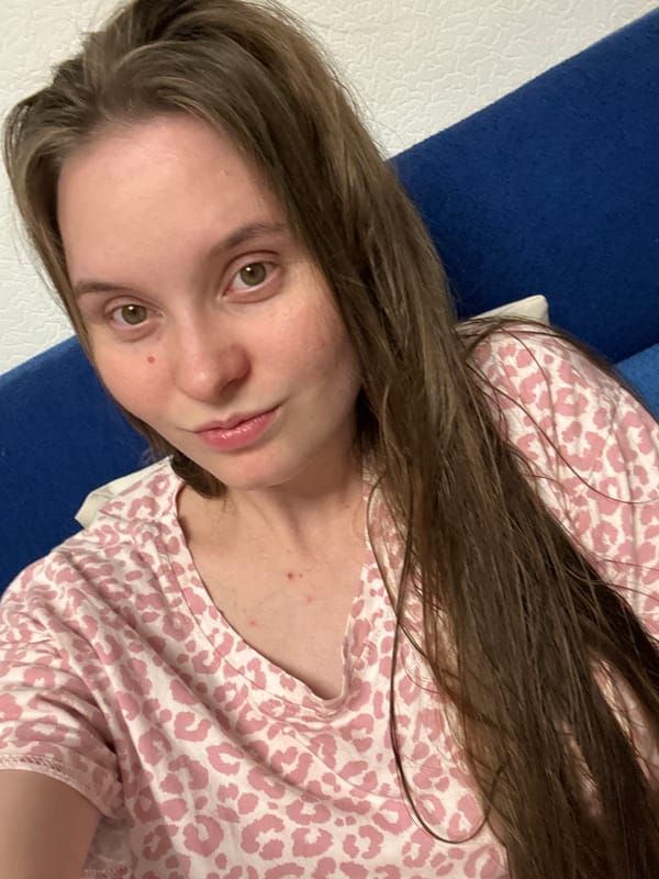 Posing for selfies at home while a soccer match plays on TV