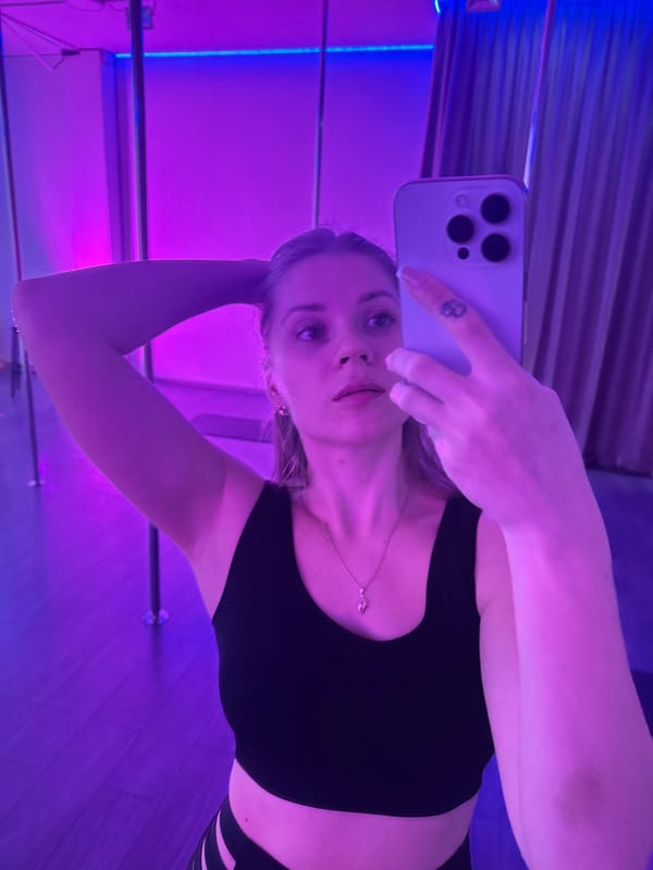 Woman takes selfies in colorful lit room in Batumi