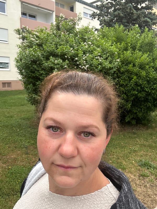 Woman documents morning dog walk amid blooming flowers in Ergolding