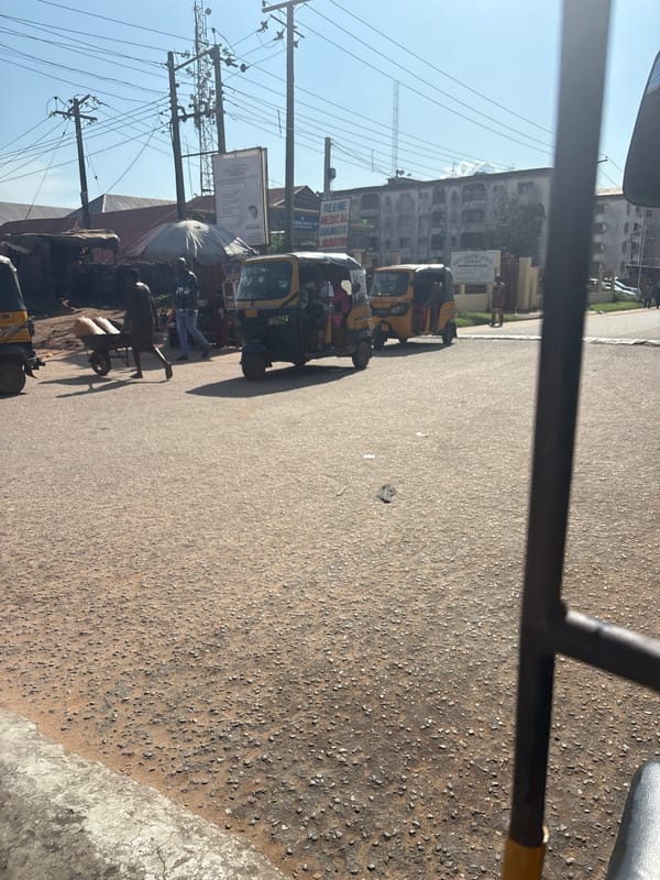 Inside and outside a Keke Napep on a Nkpor street
