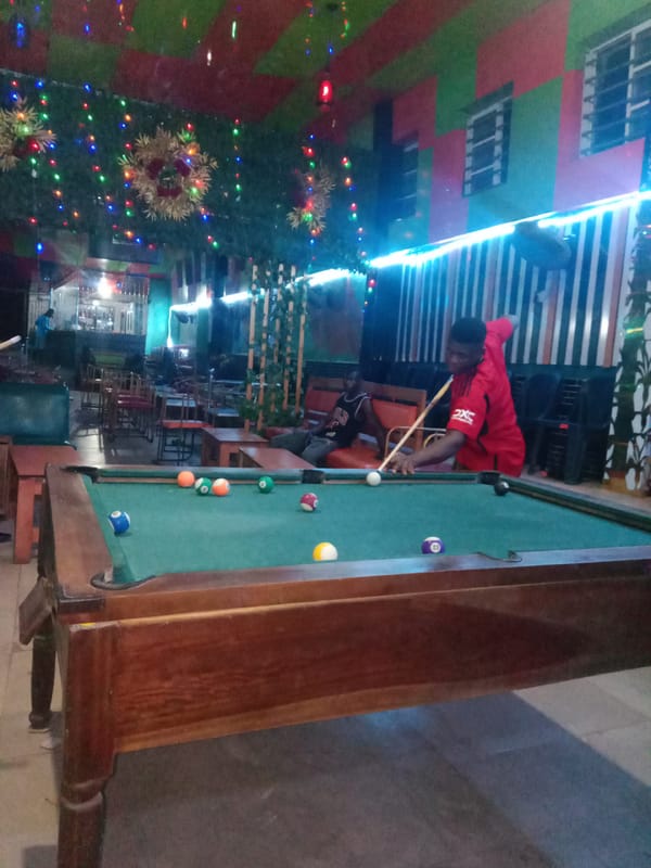 Man plays pool at entertainment venue in Onitsha