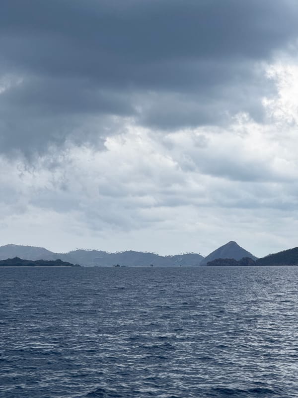 Boat crossing choppy seas off the island coast of Pasir Putih