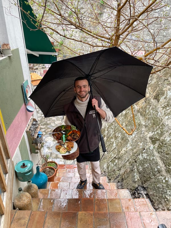 Rainy afternoon dining captured in historic Stari Bar Montenegro