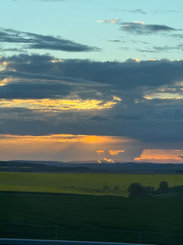 Dramatic golden sunset observed through storm clouds in Jaignes
