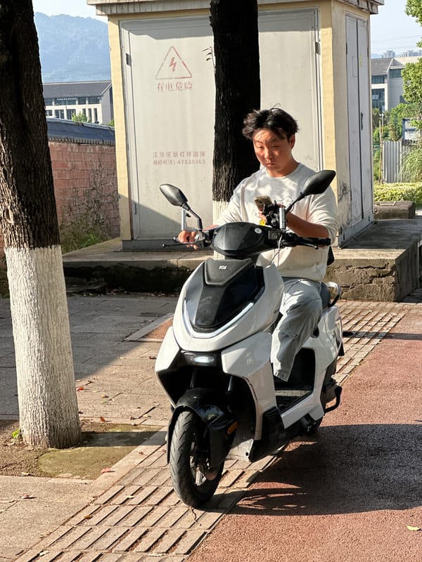 Scooter riders spotted on sunny morning in Jiangjin, China