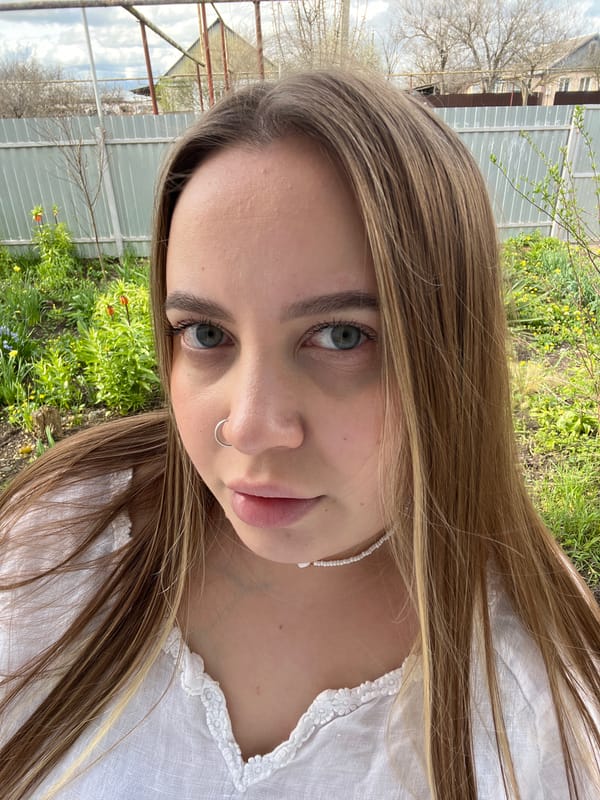 Woman relaxes with farm animals in Russian countryside
