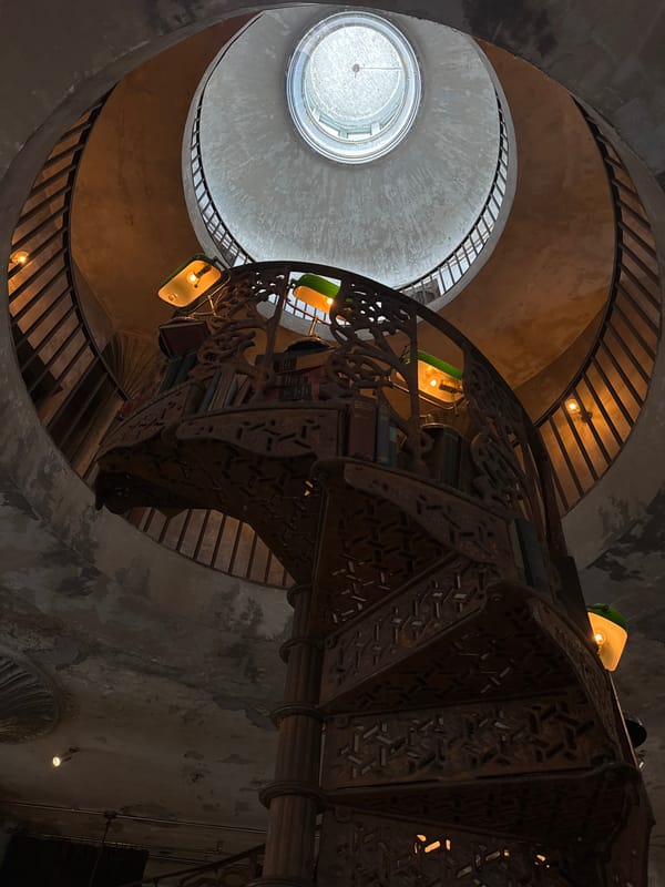 Bangkok bar with taxidermy, spiral stairs, and old-world atmosphere