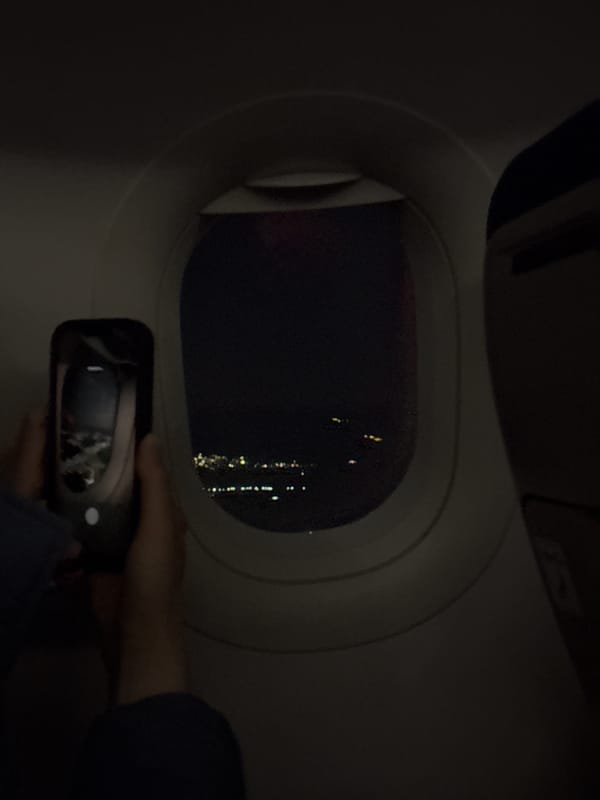 Airplane passenger photographs through window during night flight over Armenia