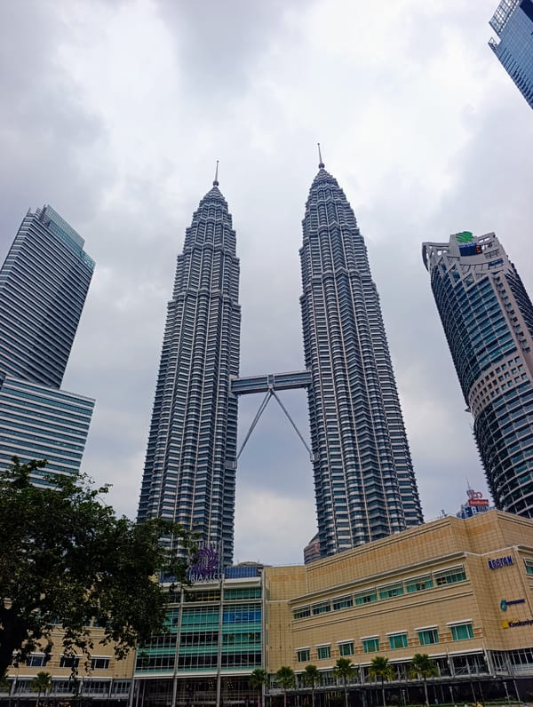 Morning view captured of Petronas Towers under cloudy skies