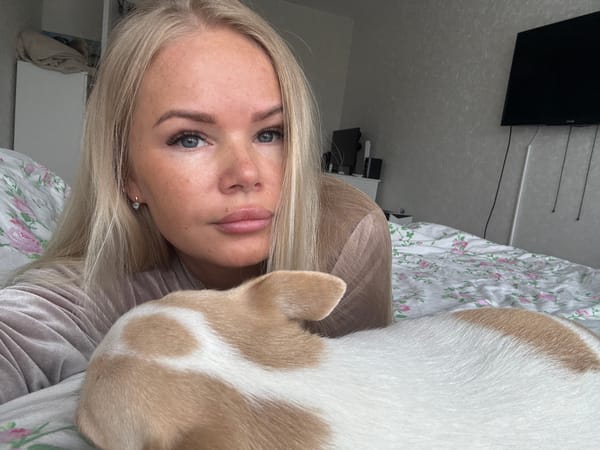 Woman and chihuahua share quiet morning moment in bedroom