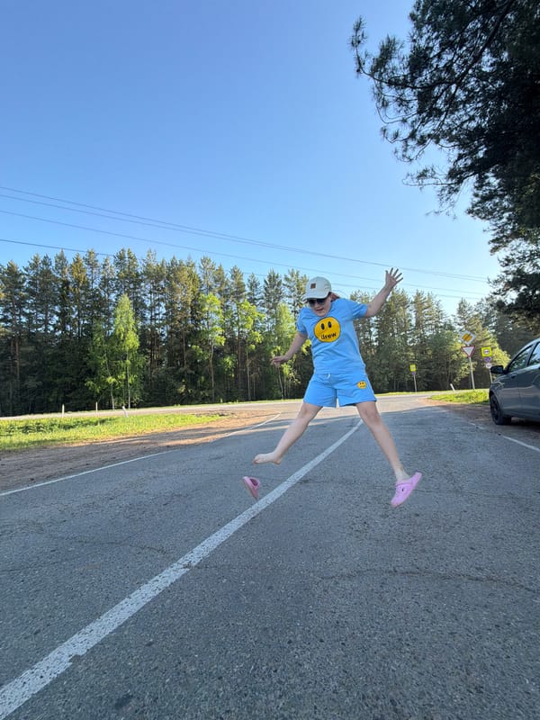 People pose playfully on rural road in Foki, Russia