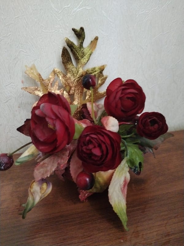 Tabletop still life: dark florals and a fairy figurine