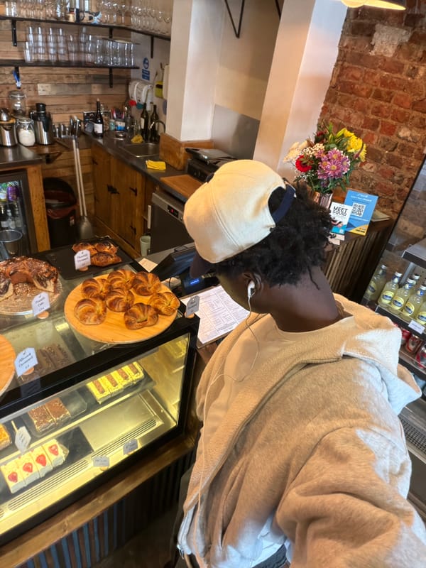 Customer browses baked goods at London cafe counter