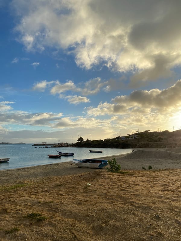 Sunset hour across Juan Griego's bay, beach, and hillsides