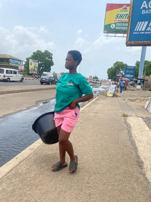 Daily street life unfolds in commercial Accra district