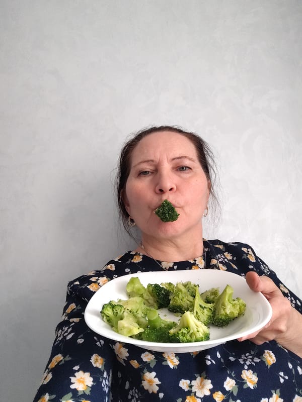 Woman plays with food, poses playfully in Sarapul kitchen