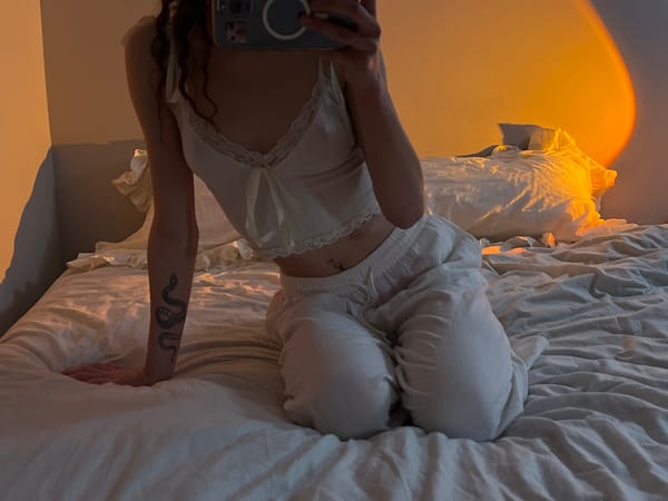 Woman takes evening selfies with cat in Ternopil bedroom