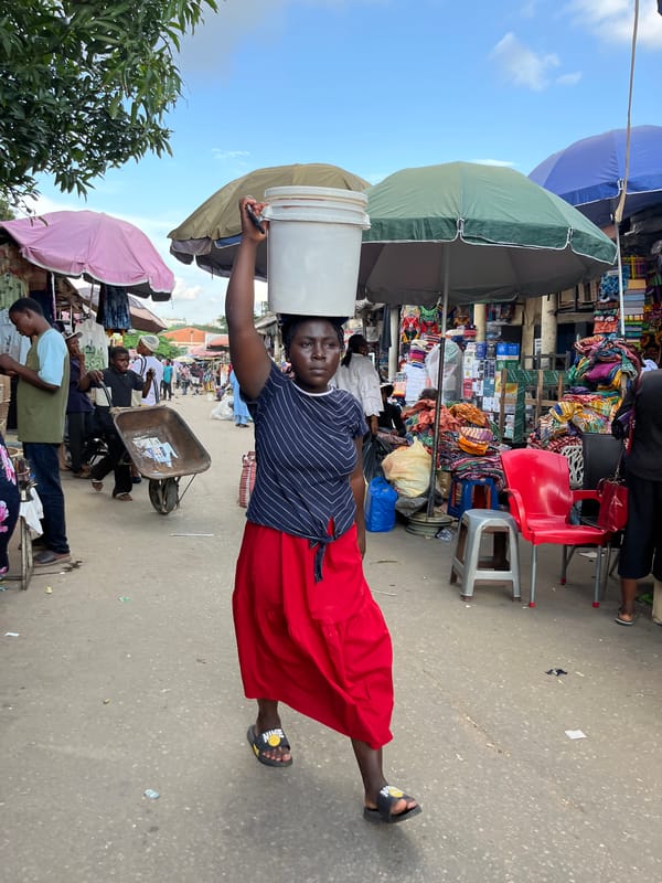 Abuja street market buzzing with vendors and shoppers