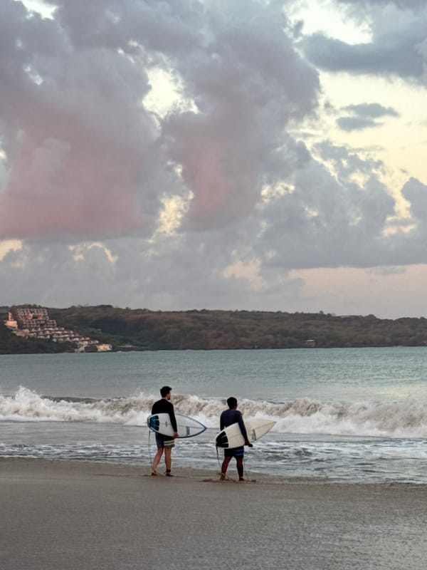 Kuta Beach at sunset — surf, sky, and everyday Bali details