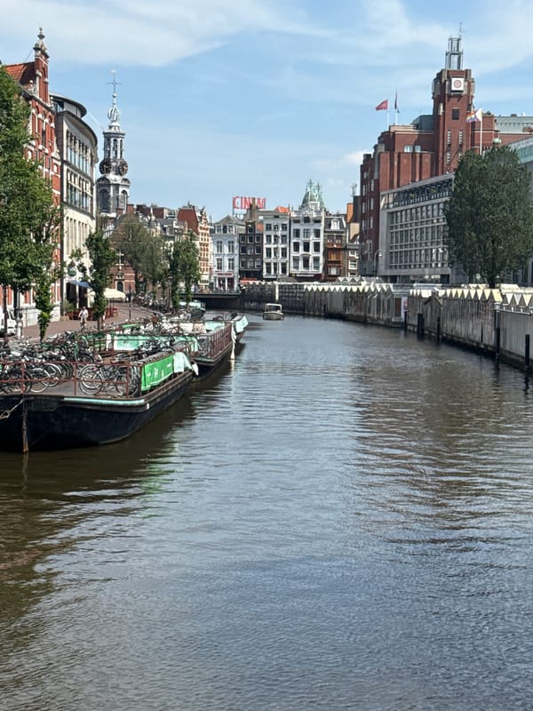 Amsterdam streets and canals during Pride, sunny June afternoon