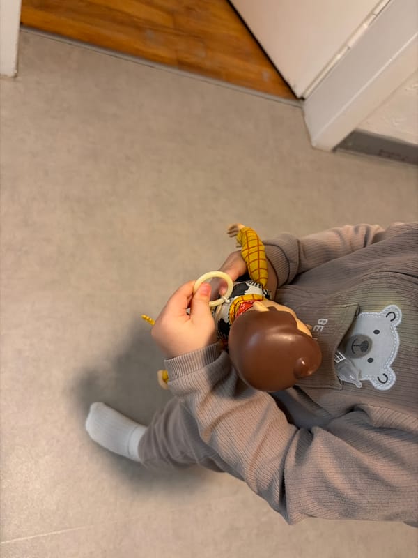 Child plays with Woody doll at home in Luxembourg