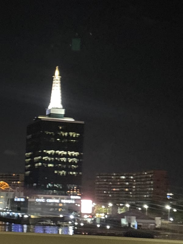 Ikoyi's Civic Centre Towers illuminated in evening cityscape