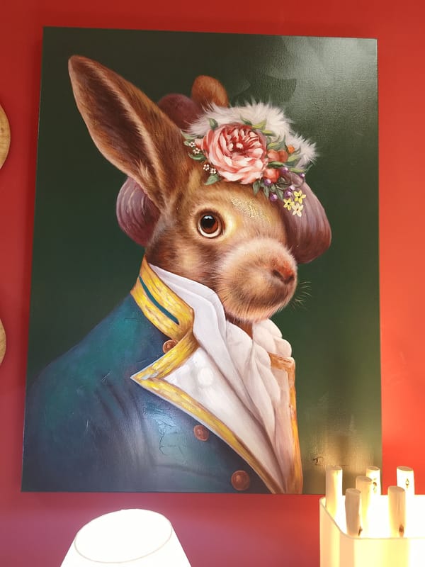 Formal rabbit portrait spotted on red wall