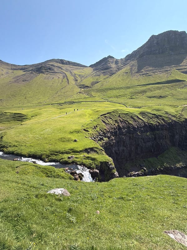 Cliffs, waterfalls, and puffins at Gásadalur, Faroe Islands