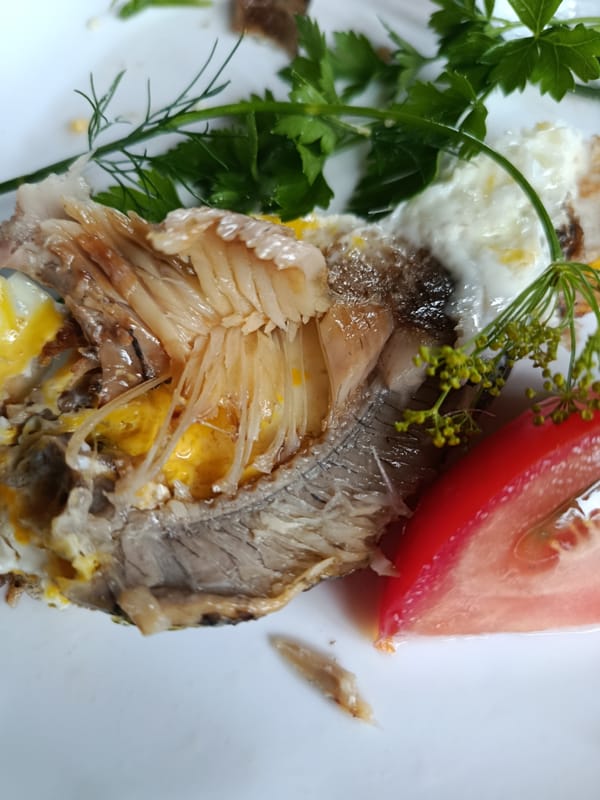 Breakfast table with fish, eggs, and fresh fruit