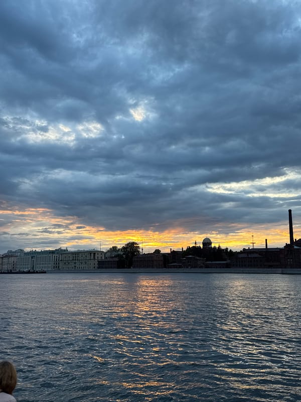 Neva River at dusk, storm clouds and a vivid sunset.