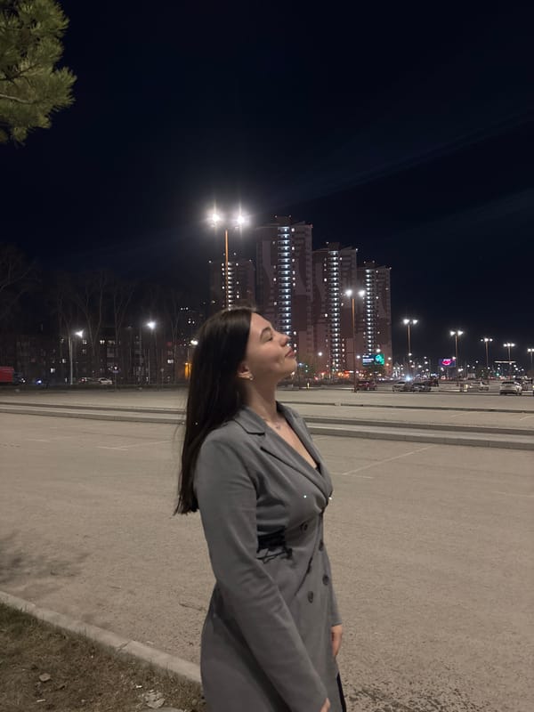 Woman poses for nighttime photos in downtown Perm