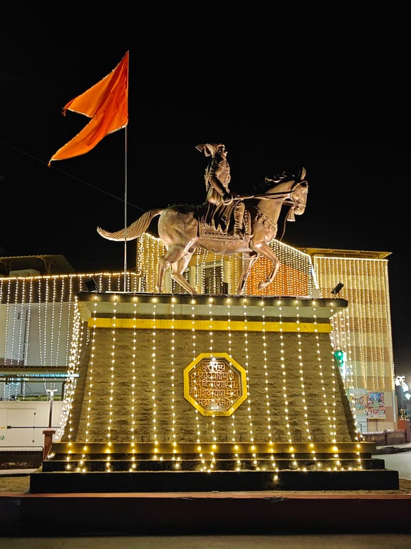 Illuminated monuments and temples captured at night in Mapusa