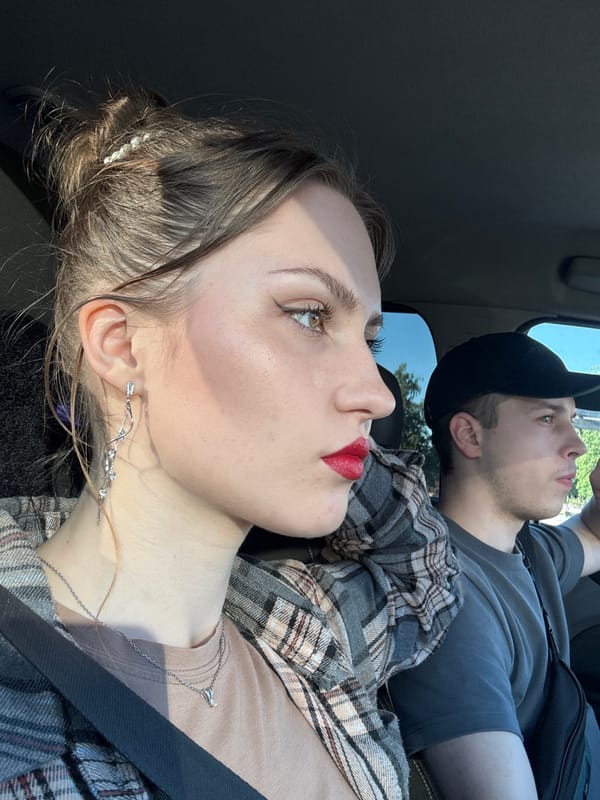 Young adults in vehicle, delivery scooter spotted in Saint Petersburg