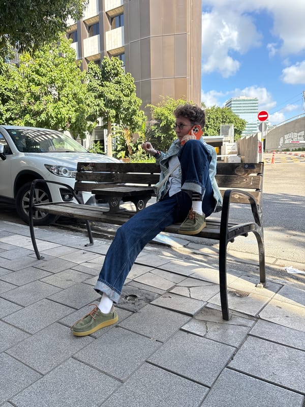 Beagle enjoys coffee from cup on Tel Aviv street