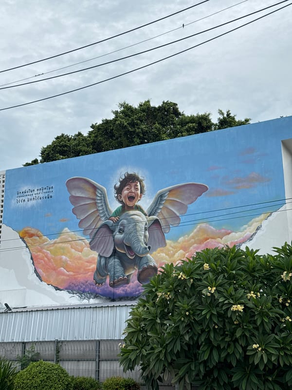 Whimsical mural shows child riding winged elephant in Thailand