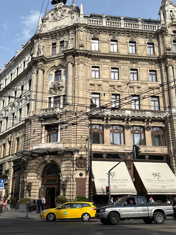 Silver truck parked outside historic New York Café Budapest