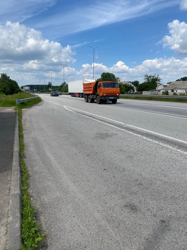 Heavy truck traffic moves through a Ukrainian highway corridor